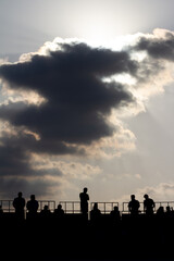 vertical shot of the silhouette of bullfight spectators