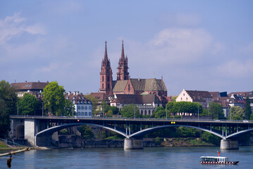 Naklejka premium Skyline of the old town of Basel with Basler Minster and Wettstein Bridge in the foreground on a blue cloud spring day. Photo taken April 27th, 2022, Basel, Switzerland.