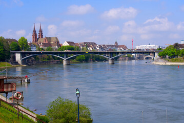 Naklejka premium Skyline of the old town of Basel with Basler Minster and Wettstein Bridge in the foreground on a blue cloud spring day. Photo taken April 27th, 2022, Basel, Switzerland.