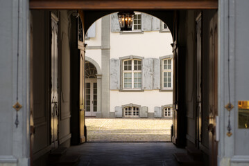 Gateway with lantern at the ceiling at the old town of Basel on a sunny spring day. Photo taken April 27th, 2022, Basel, Switzerland.