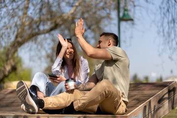 Couple talking outdoors in a park with a green background