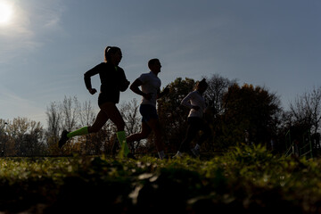 Silhouettes running outside