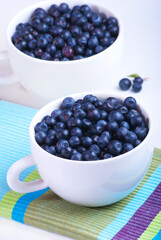 Two white plates with blueberries