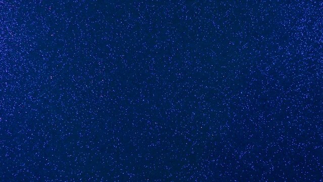 Flashing background.  Light beams of pink and blue are flashing on a blue shiny background.