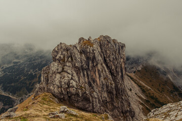 Misty and foggy morning on top of the hill Visevnik. Cloudy mountain panorama in the Julian Alps