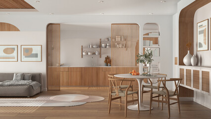 Modern kitchen, living and dining room in white tones, velvet sofa with carpet, wooden sliding door, cabinets, shelves and table with chairs. Parquet and cane ceiling. Interior design