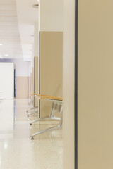 Hospital waiting room with chairs and reflections on the floor