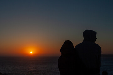 a couple in love enjoy the sunset in the Portuguese fortress of Sagres