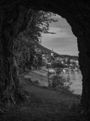 View of the city of Hainburg from a rock tunnel in black and white, Austria