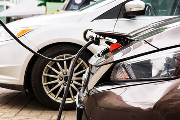 Fototapeta premium Electric car at the charging station. Ecology. Eco-friendly transport