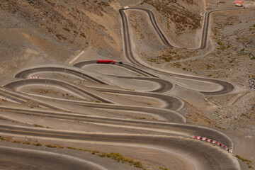 Transportation. Cuesta Caracoles desert highway, with many curves, in the Andes mountains. 