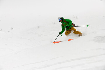 close-up view of active athlete riding down snow-covered mountain on splitboard