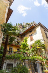 Fototapeta na wymiar Residential houses in the Italian town of Arco on Lake Garda under blue sky and light clouds