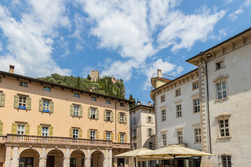 Obraz premium Residential houses in the Italian town of Arco on Lake Garda under blue sky and light clouds