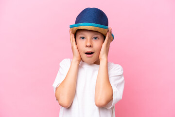 Little caucasian boy wearing a hat isolated on pink background