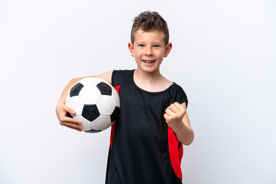Little caucasian boy isolated on white background with soccer ball celebrating a victory