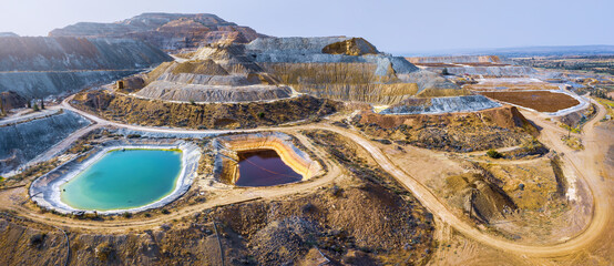 Aerial panorama of Skouriotissa copper mine in Cyprus with ore piles and multicolored pools - obrazy, fototapety, plakaty