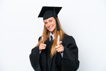 Young university graduate caucasian woman isolated on white background pointing to the front and smiling