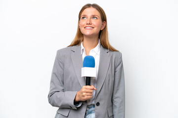 Young caucasian tv presenter woman isolated on white background thinking an idea while looking up