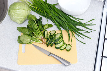 knife and vegetables for salad on the kitchen table. prescription