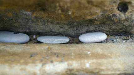 three sea stones on the rock