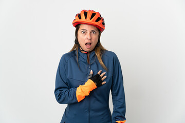 Middle age cyclist woman isolated on white background surprised and shocked while looking right