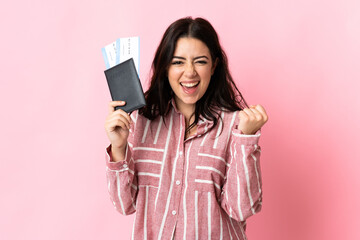 Young caucasian woman isolated on pink background happy in vacation with passport and plane tickets