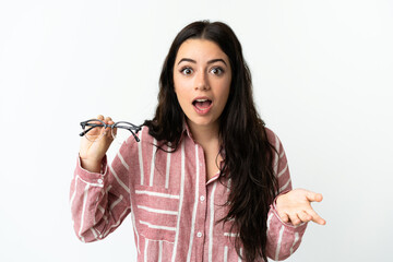 Young caucasian woman with glasses isolated on white background with shocked facial expression