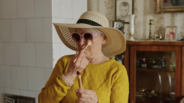 Elderly woman's daily routine, senior lady wearing modern sunglasses and hat. High quality 4k footage