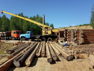 Fototapeta premium Preparation of logs for the construction of an eco-house. High quality photo