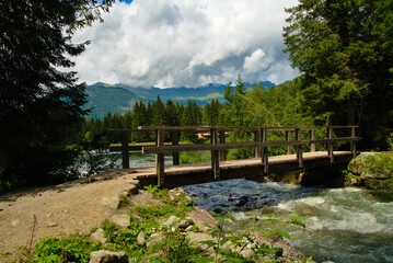 wooden bridge over the stream on Dolomites, Italy