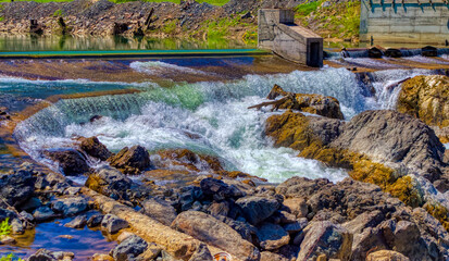 Fototapeta na wymiar River waterfall passing over rocks.
