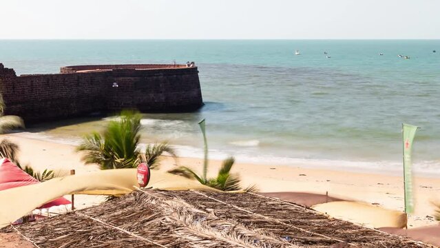 4K time lapse footage at the Sinquerim Beach in Goa with tourists enjoying the  the ocean view and watersport activities in the evening