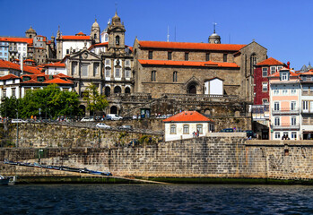 Fototapeta premium View of the historic part of Porto with its stone buildings and the river Douro on a sunny summer day in northern Portugal