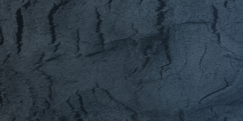 Fototapeta premium Ancient texture of old wall with grainy and scratched cracks, Black or dark blue grunge texture with space for text, Grunge concrete wall with black vintage distressed grunge texture.