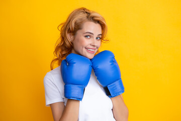 Happy smiling portrait of beauy woman in boxing gloves. Winning success power woman concept.