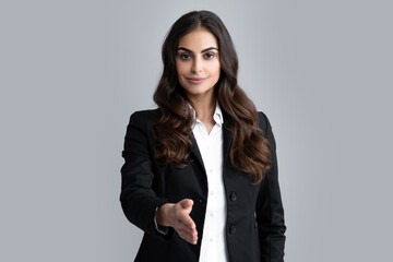 Business woman in suit smiling friendly offering handshake as greeting and welcoming. Successful...