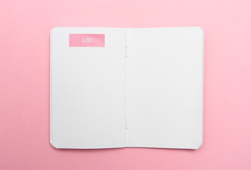 To do list in notebook on pink background