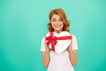 smiling girl hold heart present box on blue background