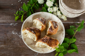Fresh homemade baguette bread on wooden table. Healthy vegan eco food concept