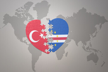 puzzle heart with the national flag of turkey and cape verde on a world map background. Concept.