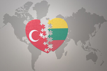 puzzle heart with the national flag of turkey and lithuania on a world map background. Concept.