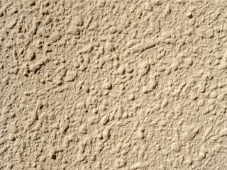 Texture, beige concrete wall with shagreen finish close-up. Copy spase 