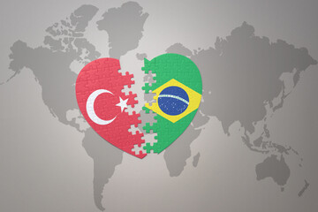 puzzle heart with the national flag of turkey and brazil on a world map background. Concept.