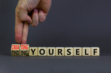 Finding or creating yourself symbol. Businessman turns wooden cubes and changes words Finding yourself to Creating yourself. Beautiful grey background, copy space. Business creating yourself concept. - obrazy, fototapety, plakaty