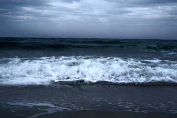 Landscape of blue ocean waves with beautiful clouds.