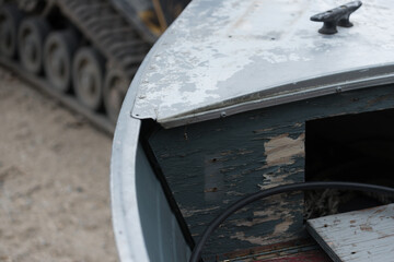 detail of an old motor powered boat (cleat, hitch, rope, tractor)