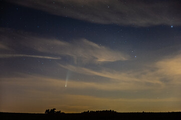 Night time landscape shot of rural belgium with comet NEOWISE prominently in the sky.
