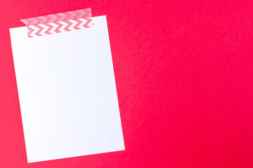 White notebook paper sheet mockup on red background with copy space. Letter template for valentine day, invitation, memo, message
