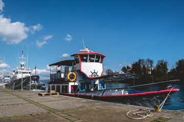 Traditional tourism boats and ships at dock in Calle-calle river in Valdivia with beautiful blue sky, Chile